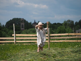 Life of a child in the village. Children's work in the hay field