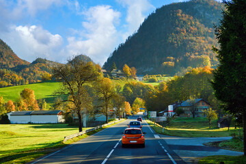 The car runs on a road with beautiful nature, high mountains and beautiful cities on the hills in...