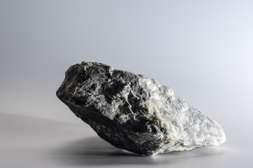 a piece of granite stone on a light gray background