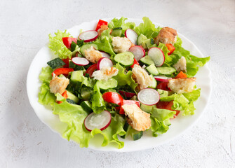Summer vegetarian fattoush salad of vegetables and toasted pita bread on a light background.