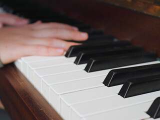 Fototapeta premium Practicing on piano, Teenager's hand, black and white keys, Concept developing finger's motion skill,