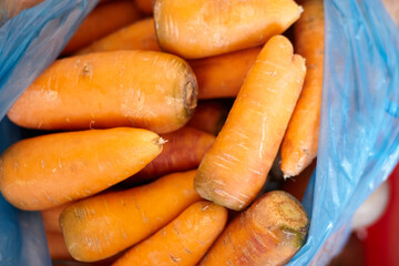 Pile of fresh organic carrots. Healthy eating. Purchasing fresh vegetables in the market