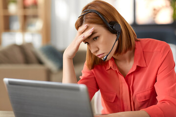 remote job, technology and people concept - sad young woman with headset and laptop computer having...