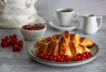 Traditional French breakfast. Fresh butter croissants with berries, jam, and coffee. 