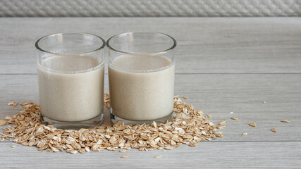 Close up homemade oat milk in small drinking glass with seed