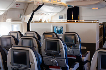 Empty cabin of a large aircraft with rows of seats