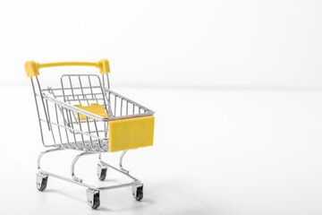 Shopping cart on white background, Empty metal shopping cart or trolley on white viewed sideways conceptual of shopping, consumerism, retail and e-commerce