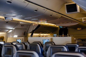 Empty cabin of a large aircraft with rows of seats
