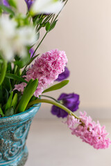 Bouquet of pink hyacinthus in a turquoise rustic vase