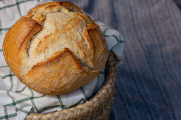 large piece of bread in a basket, with copy space