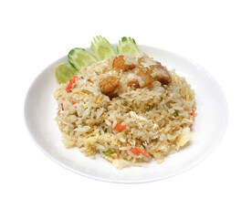 Fried rice with crispy pork served with cucumber and lime on white plate, isolated on white background. Ingredients include jasmine rice, carrot, egg, spring onion and crispy pork.
