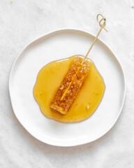 Honeycomb in White plate on marble background with copy space