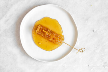 Honeycomb in White plate on marble background with copy space