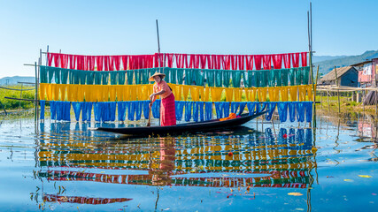 Intha people working with handcrafted colorful lotus fabrics in inle lake is life style of intha...