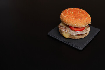 hamburger on top of a black table with copy space