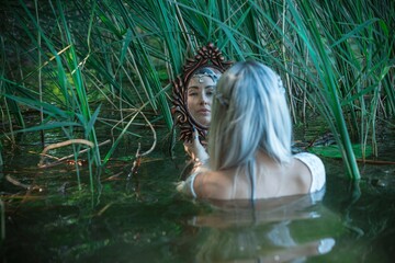 Old European magic, Mystical Pagan scene, woman in lake, rituals. Magic divination in water, ritual. Psychic vision, fortune teller