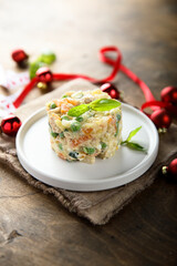 Traditional homemade Olivier salad on a white plate