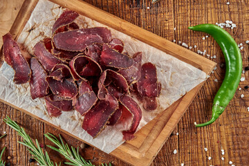 An appetizing beer snack is basturma, a traditional Armenian dried meat (pork or beef). Close up on tasty jerky snack
