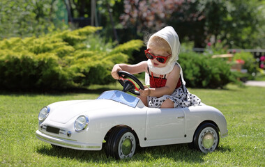 Cute child drive a toy car