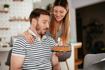 Husband's birthday. Wife surprise husband with birthday cake	
