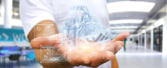 Businessman holding and touching wireframe holographic digital projection of an engine 3D rendering