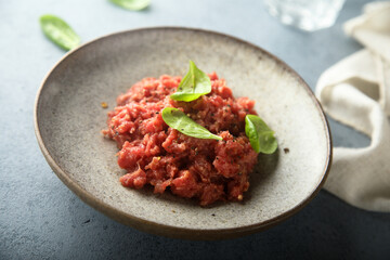 Traditional steak tartare with fresh basil