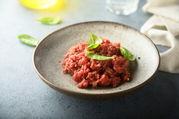 Traditional steak tartare with fresh basil