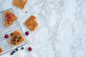 Waffles with fresh fruit on top view.