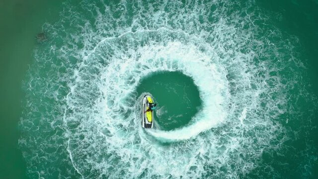 Vedio People are playing a jet ski in the sea.Aerial view. and top view.amazing nature background.The color of the water and beautifully bright.  Adventure day.clear turquoise at tropical be
