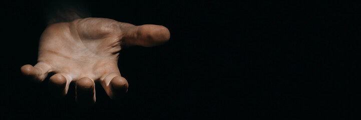 asking hands of a working man in the dark