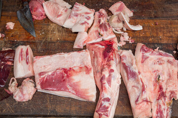 Meat for sale over wooden table, top view
