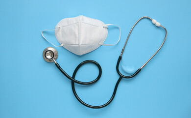 Stethoscope medical equipment with KN95 face mask on blue background covid-19 Coronavirus...