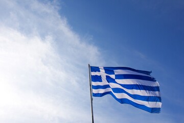 Greece flag fluttering in the sky