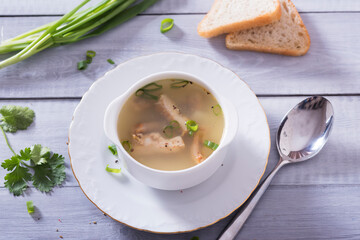 Fresh fish soup with ingredients and spices for cooking. Woodn background