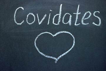 
Covidence - inscription on a chalk board. A way to make an acquaintance during the COVID-19 pandemic