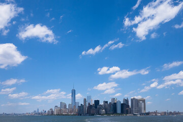 Skyline of downtown Manhattan New York during daytime as seen from a boat. Space for text on sky.