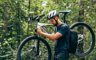 Side view of professional male cyclist cycling on mountain road on nature background. Young man...