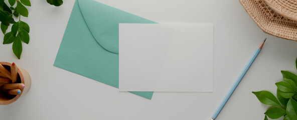 Mock-up greeting card, turquoise envelope, card paper with pencil and decorations © bongkarn