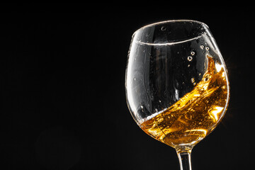 Glass of wine on black background, close up