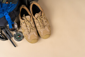 Blue backpack and hiking boots. Mountain gear close up