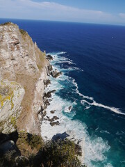 White waves crushing to the rocky hill
