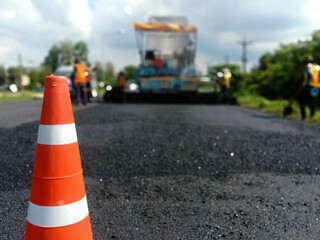 Blur image, asphalt road maintenance work And there is a red rubber cone in the front