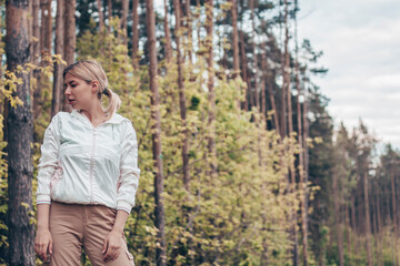 Young girl in the woods girl walks in the forest. Happy, outdoor.