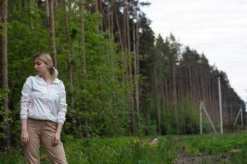 Young girl in the woods girl walks in the forest. Happy, outdoor.