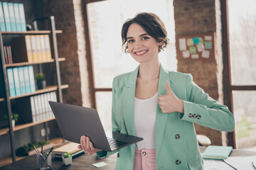 Photo of beautiful business lady hold notebook chatting colleagues raise thumb finger up insurance agent home remote work wear blazer near table modern interior home office indoors