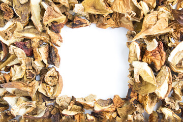 Background of dried mushrooms on a white surface. Porcini mushrooms, aspen, boletus. Photo background, texture with copy space.