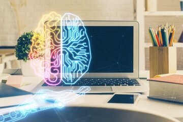 Double exposure of work space with computer and human brain drawing hologram. Brainstorm concept.