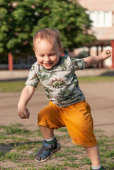 Little boy having fun jumping in the yard.