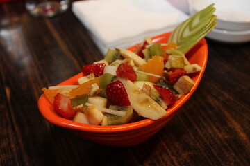 Fresh Fruit Salad in Red Bowl on Dark Background