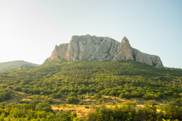 Fototapeta na wymiar Parsuk-Kaya Mountain With Green Forests In Sunny Day In Summer In Crimea, Russia.
